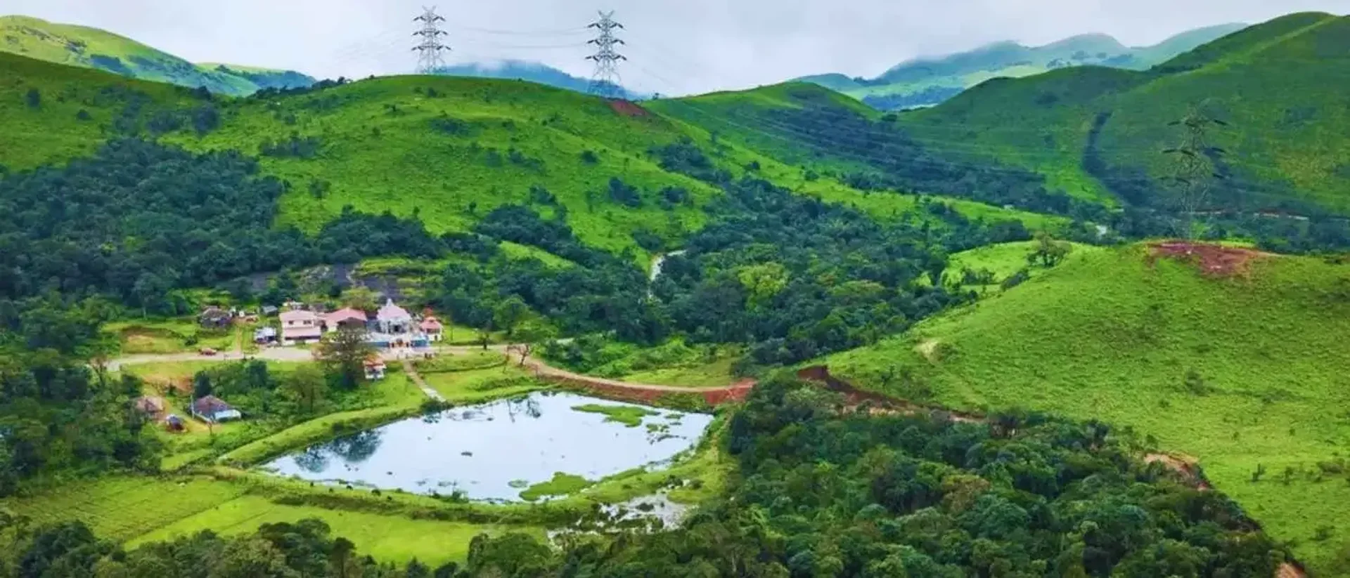 An aerial view of the Kalabhaireshwara Temple, pond and hills at Devaramane Betta